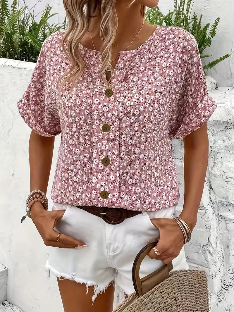 Light floral blouse from Lumina Wear featuring a relaxed fit and button front, styled with soft fabric and vibrant floral pattern.