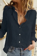Light blue Julia relaxed button blouse by Lumina Wear, featuring a classic silhouette and elegant design, worn with rolled sleeves.