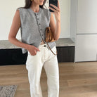 Kylie Lumina relaxed knitted vest with button-front closure and rolled-edge detail, featuring soft, textured fabric and classic style.