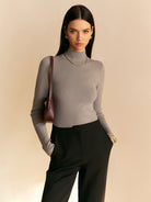 Light beige women's top with elegant mock neck and relaxed fit by Lumina Wear, styled on a model against a neutral background.