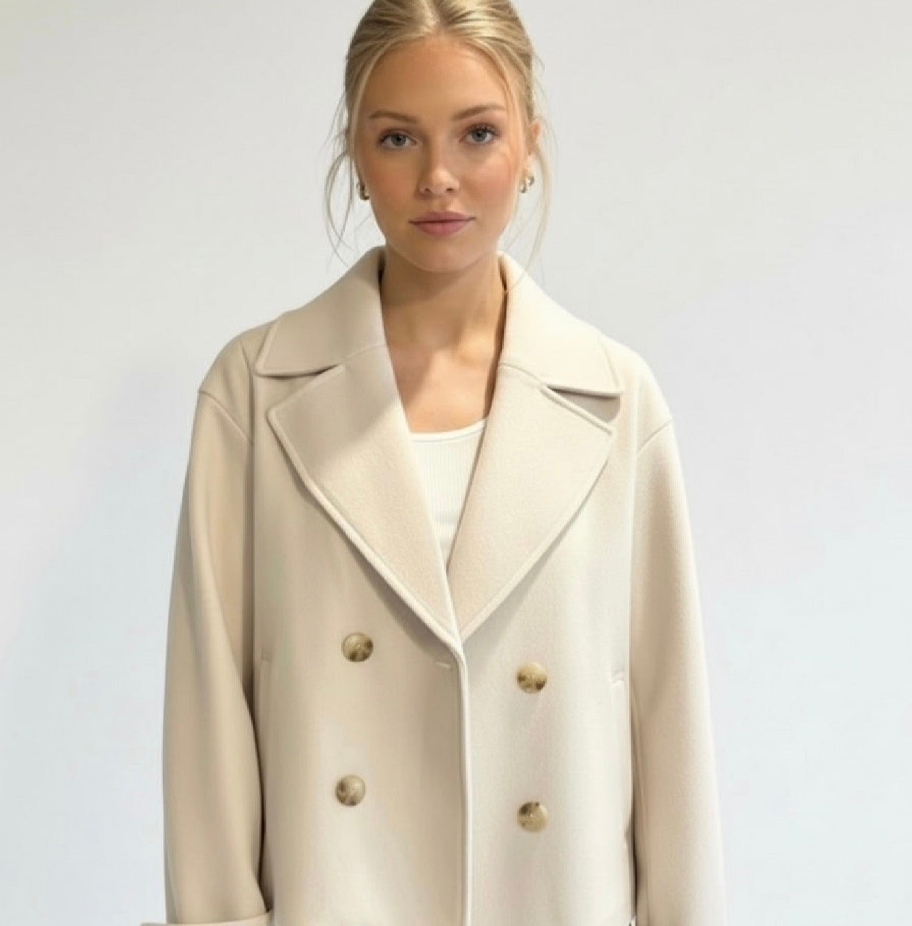 Maya Lumina cropped double-breasted trench coat with structured shoulders, stylish and tailored for a modern look.