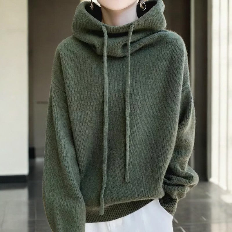 Relaxed oversized Merino wool hoodie by Lumina Wear featuring adjustable neck and breathable fabric, styled casually in the image.