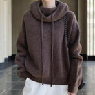 Relaxed oversized Lumina Wear Merino wool hoodie with adjustable neck and breathable fabric, shown on a model.