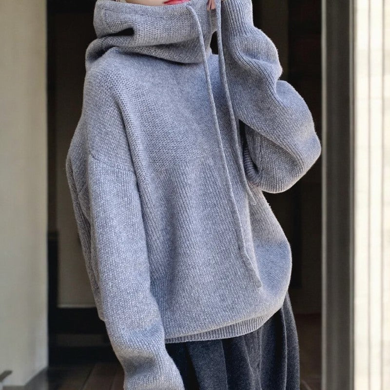 Lumina Wear Milan oversized merino wool hoodie with adjustable neck, relaxed fit, breathable fabric, shown in a cozy, casual style.