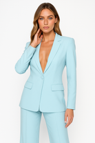 Olivia women's tailored trouser suit set with plunging neckline by Lumina Wear, featuring sleek fabric and stylish design.