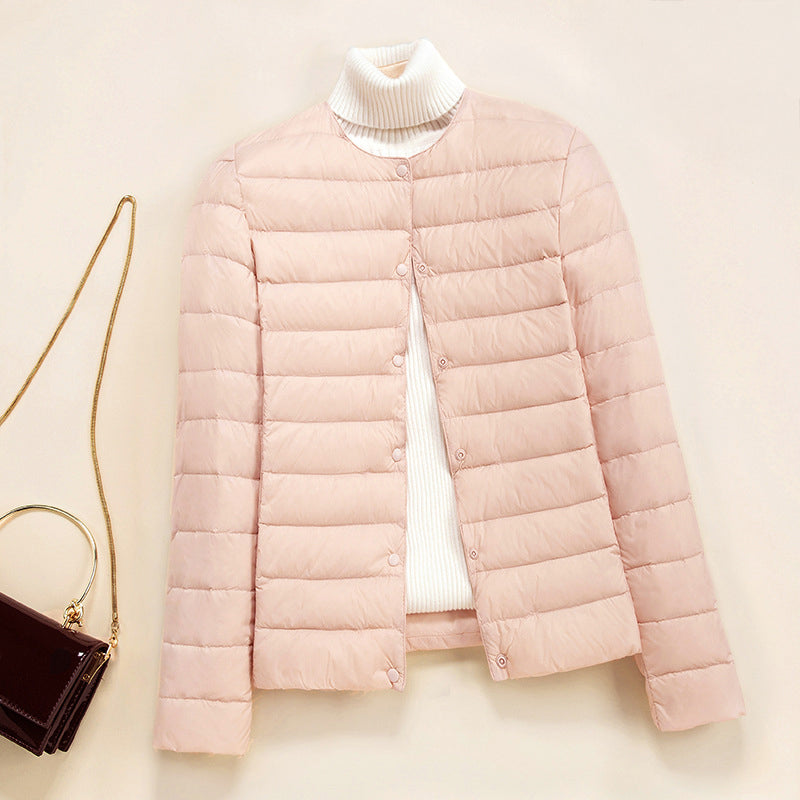 Lightweight quilted puffer jacket by Lumina Wear with snap button closure, shown in a stylish down jacket design.