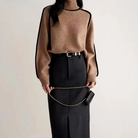 Lumina Wear Sloane minimalist high neck ribbed sweater with elegant piping, shown in a neutral color on a mannequin.
