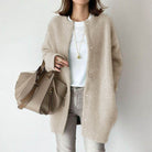 Women's relaxed fit wool cardigan with suede accents by Lumina Wear, featuring a cozy, stylish design in neutral tones.