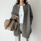Women's wool cardigan by Lumina Wear featuring a relaxed fit and suede accents, styled with a cozy, casual look.
