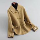 Elegant knit coat by Lumina Wear featuring pearl buttons and a distinctive collar, stylishly worn by a model.