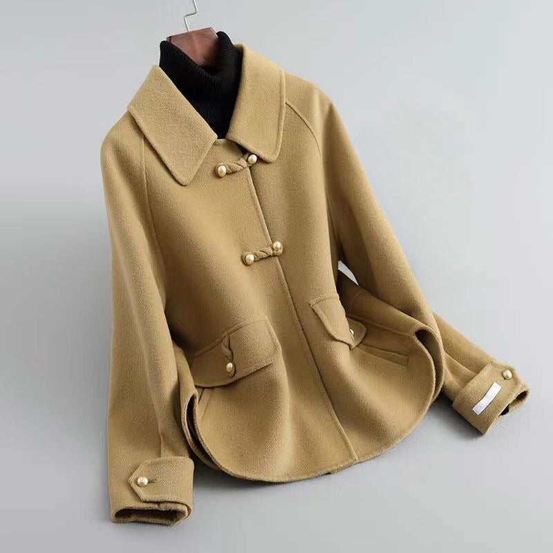 Elegant knit coat by Lumina Wear featuring pearl buttons and a distinctive collar, stylishly worn by a model.