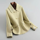 Elegant knit coat by Lumina Wear featuring pearl buttons and a distinctive collar, showcased in a stylish front view.