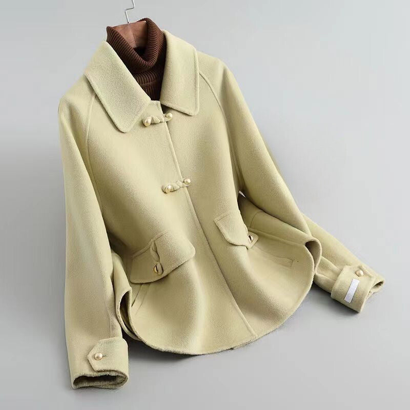 Elegant knit coat by Lumina Wear featuring pearl buttons and a distinctive collar, showcased in a stylish front view.