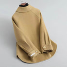 Elegant Lumina Wear Sofia knit coat with pearl buttons and a distinctive collar, shown in a stylish, close-up view.