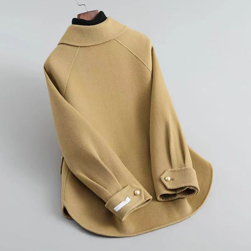 Elegant Lumina Wear Sofia knit coat with pearl buttons and a distinctive collar, shown in a stylish, close-up view.