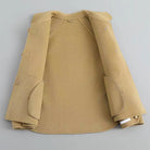 Elegant knit coat by Lumina Wear featuring pearl buttons and a distinctive collar, shown on a model.