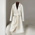 Elegant monochrome wool coat with waist belt from Lumina Wear, featuring a tailored fit and classic design.