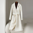 Elegant monochrome wool coat with waist belt from Lumina Wear, shown in a stylish women's coat with a tailored fit and classic design.