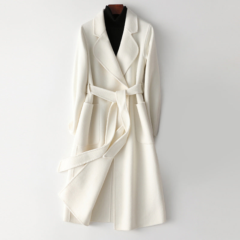 Elegant monochrome wool coat with waist belt from Lumina Wear, featuring a tailored fit and sophisticated style for women.