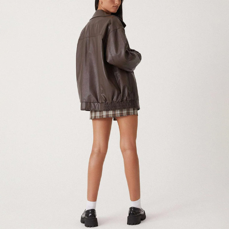 Lumina Wear Sofia oversized faux leather bomber jacket with relaxed fit, shown in black on a model.