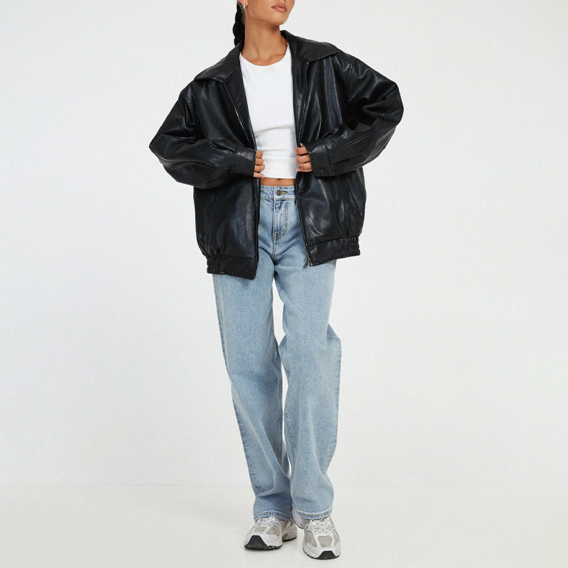 Lumina Wear Sofia oversized faux leather bomber jacket with relaxed fit, shown in a stylish, casual outdoor setting.