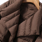 Lumina Wear Sofia quilted structured down jacket with tie belt, showcasing a fitted design and stylish collar detail.