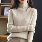 Gray and white striped oversized turtleneck sweater for women by Lumina Wear, casual and cozy, worn with jeans.