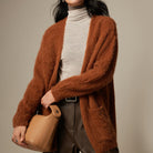 Light beige Lumina Wear Sofia ultra-soft breathable loose fit women's cardigan sweater laid flat, showing its relaxed style and fabric texture.
