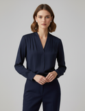 Sophia Lumina Wear elegant puff sleeve blouse with tailored waist, displayed on a mannequin in a stylish indoor setting.
