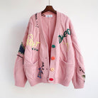 Valentina Lumina oversized patchwork knit cardigan with colorful button details, featuring a bold, cozy sweater design.