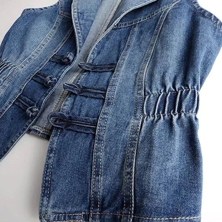Celestial medium blue washed denim vest with toggle fastenings by Lumina Wear, featuring a stylish sleeveless design.