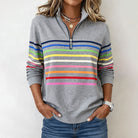Colorful striped Valentina Lumina women's half-zip pullover sweatshirt hanging on a display.