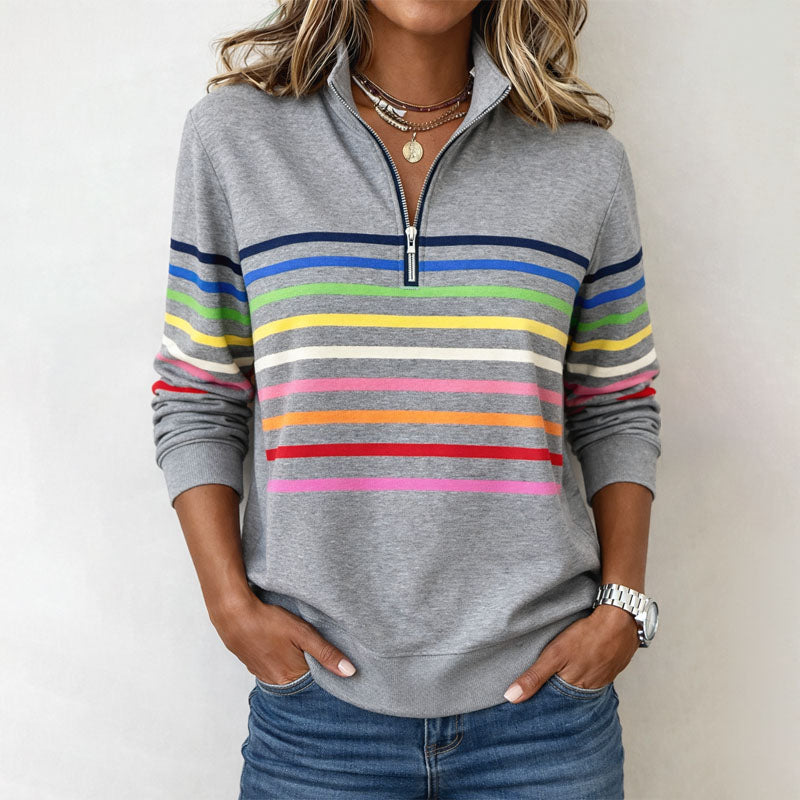 Colorful striped Valentina Lumina women's half-zip pullover sweatshirt hanging on a display.