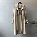 Elegant black lightweight trench coat with silky drape from Lumina Wear, featuring a sleek design and stylish silhouette.