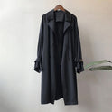 Elegant lightweight black trench coat with silky drape from Lumina Wear, featuring a sleek silhouette and sophisticated design.