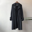 Elegant lightweight black trench coat for women with silky drape from Lumina Wear, showcasing a sleek, stylish design.