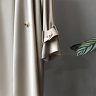 Elegant lightweight black trench coat with silky drape, designed for women by Lumina Wear.