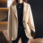 Light gray Valentina wool coat by Lumina Wear featuring a relaxed fit and classic lapel collar, displayed on a hanger.