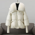 Black puffer jacket with fur collar from Lumina Wear's Valentina collection, featuring an extended length and cozy winter style.