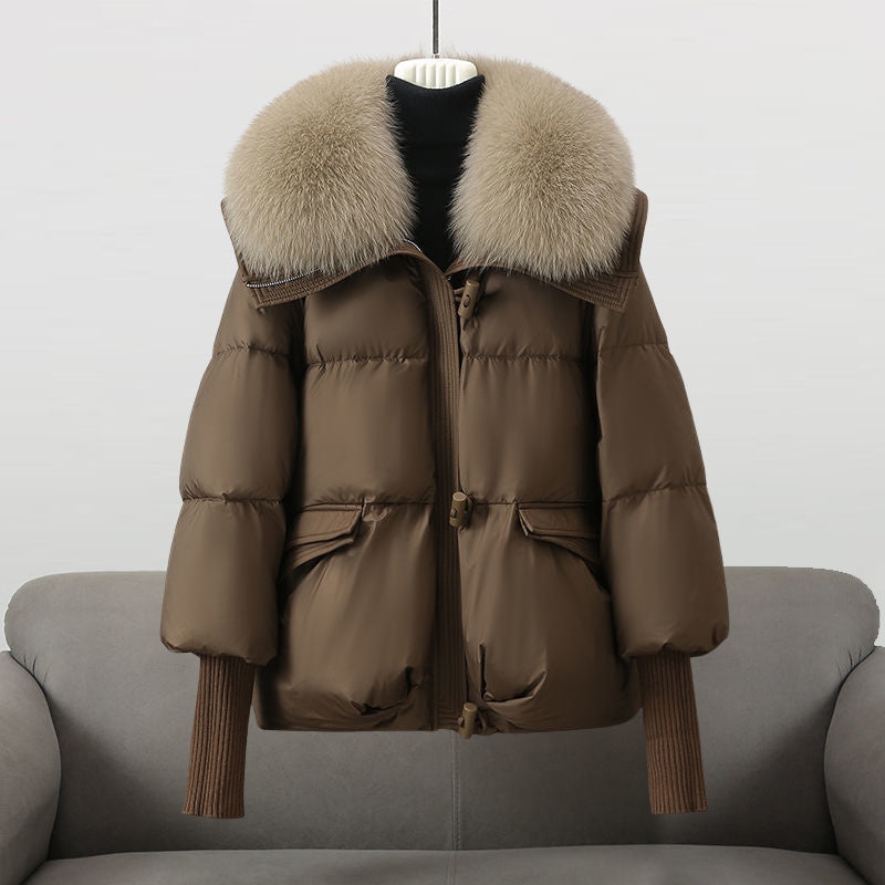 Black extended-length puffer jacket with fur collar by Lumina Wear, featuring a cozy, stylish design for cold weather.