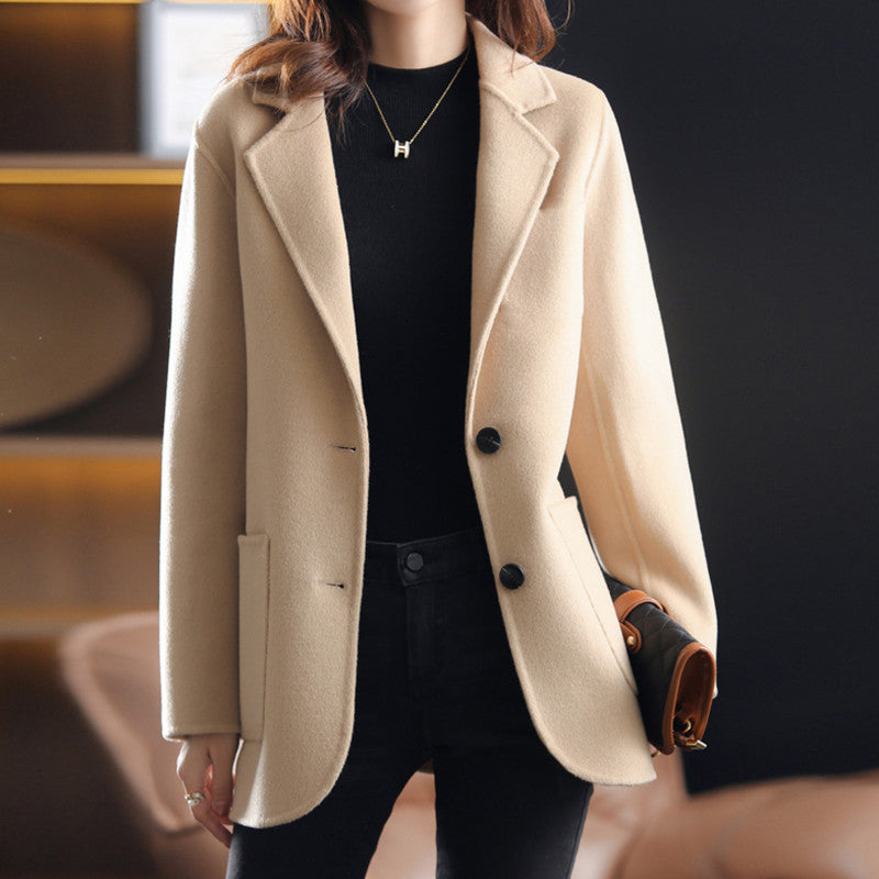Valentina Lumina Wear relaxed fit wool blend winter overcoat with lapel collar, shown in a cozy, stylish outdoor setting.