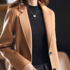 Valentina Lumina relaxed fit wool blend winter overcoat with lapel collar, shown in dark gray on a model.