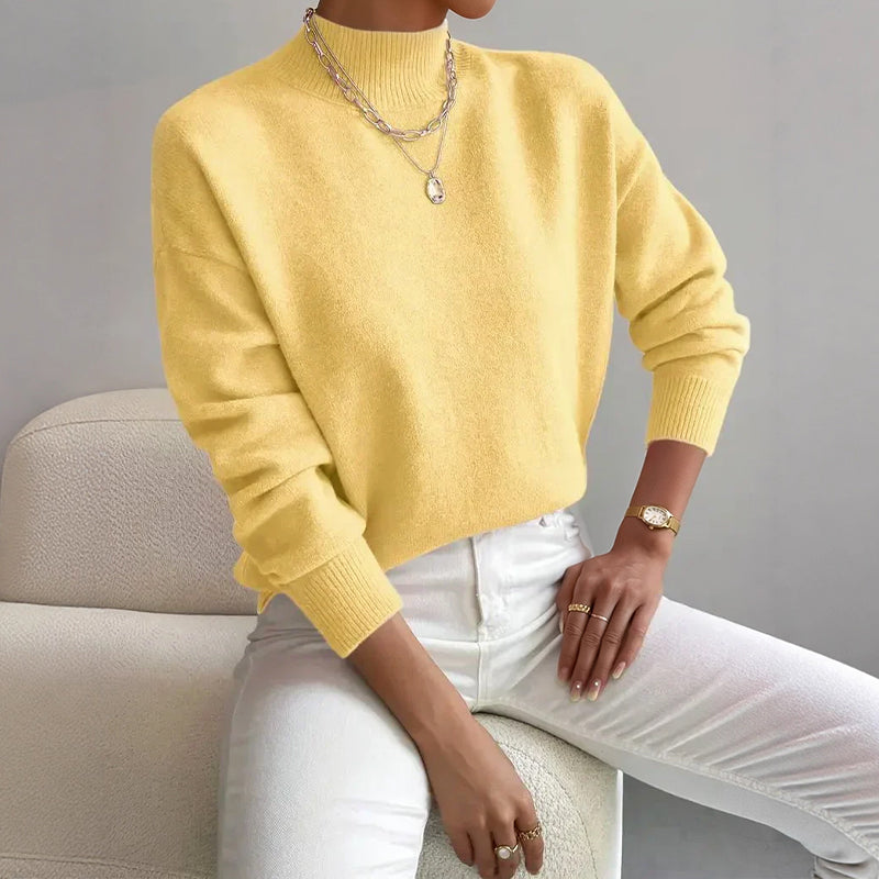 Lumina Wear Valentina relaxed mock neck knit sweater with ribbed cuffs, soft cozy knit, in neutral tones.