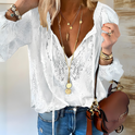 Victoria Lumina Wear elegant bohemian V-neck blouse with decorative detailing, featuring flowy fabric and unique embroidery.
