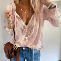Elegant bohemian V-neck blouse by Lumina Wear featuring decorative detailing and flowing fabric in a natural pose.