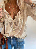 Victoria Lumina bohemian V-neck blouse with decorative detailing, featuring flowing fabric and intricate embellishments.