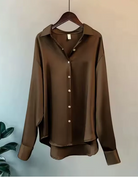 White button-down blouse with relaxed fit by Lumina Wear, featuring elegant design and classic collar for a sophisticated look.