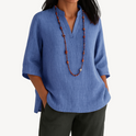 Lumina Wear Victoria linen tunic top featuring a relaxed fit and minimalist design, shown in natural beige fabric.