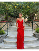 Red Aliza ruffled maxi dress by Lumina Wear, perfect for wedding guests, featuring flowing fabric and elegant ruffle details.