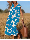 Black Alvina Relaxed Abstract Dress by Lumina Wear, casual fit with artistic pattern, displayed on a hanger.
